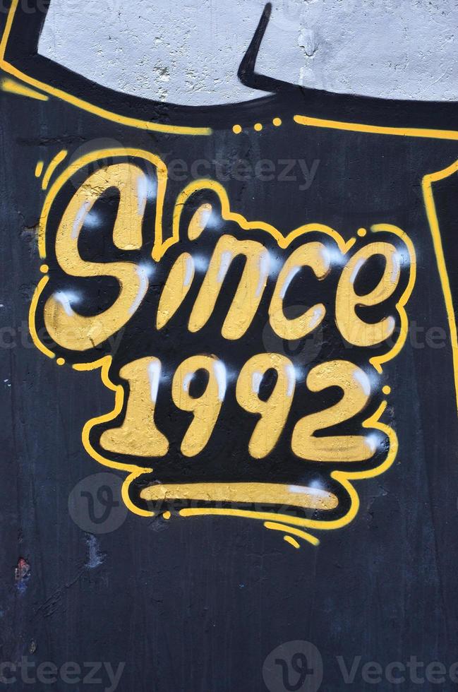 Texture of a fragment of the wall with graffiti painting, which is depicted on it. An image of a piece of graffiti drawing as a photo on street art and graffiti culture topics