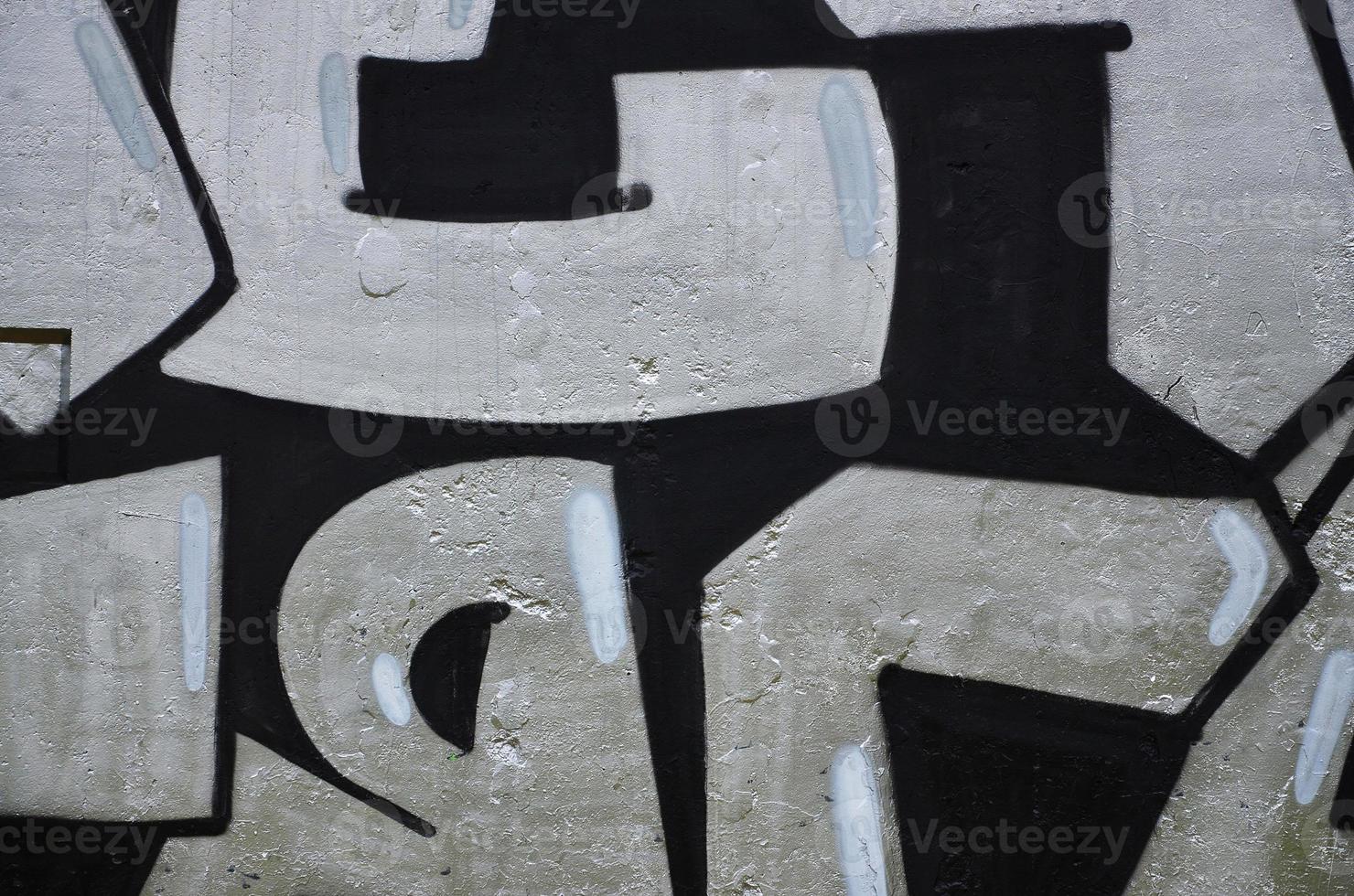 Texture of a fragment of the wall with graffiti painting, which is depicted on it. An image of a piece of graffiti drawing as a photo on street art and graffiti culture topics