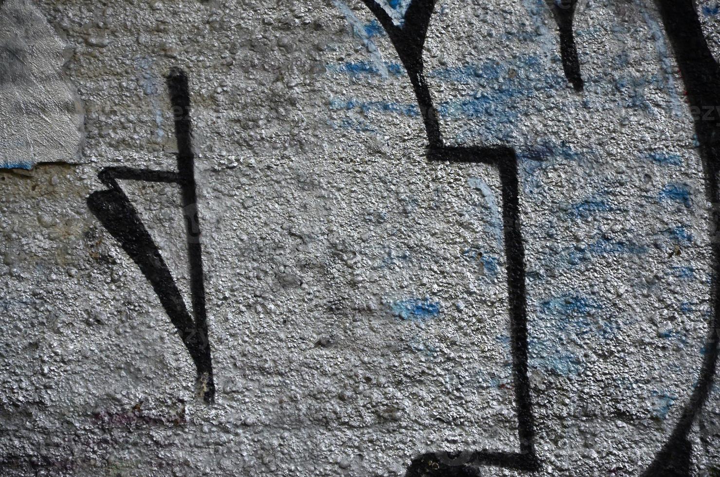 Texture of a fragment of the wall with graffiti painting, which is depicted on it. An image of a piece of graffiti drawing as a photo on street art and graffiti culture topics