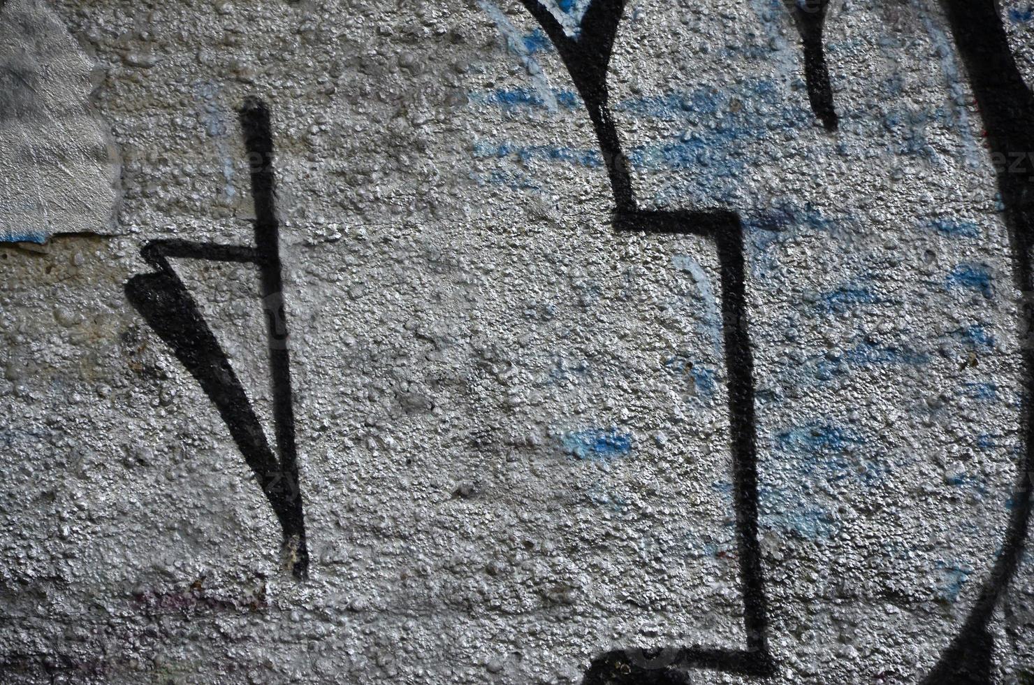 Texture of a fragment of the wall with graffiti painting, which is depicted on it. An image of a piece of graffiti drawing as a photo on street art and graffiti culture topics