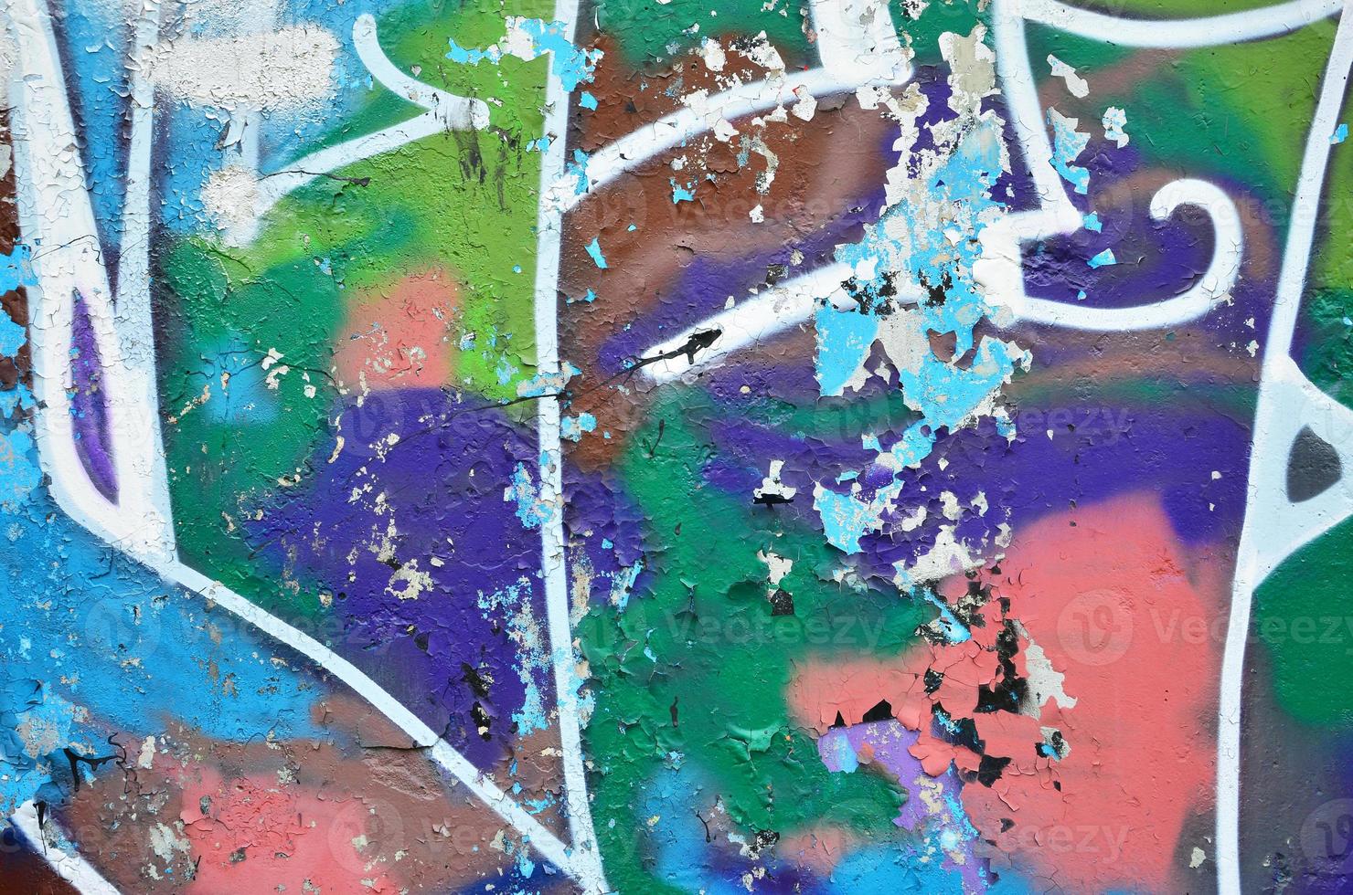 Texture of a fragment of the wall with graffiti painting, which is depicted on it. An image of a piece of graffiti drawing as a photo on street art and graffiti culture topics