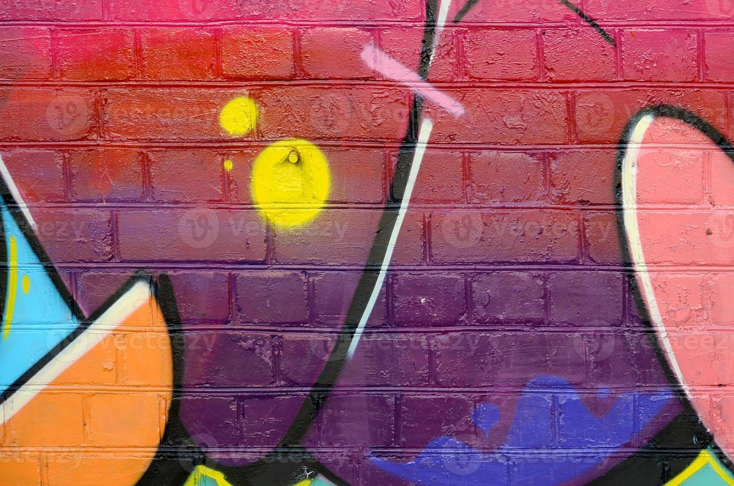 Abstract colorful fragment of graffiti paintings on old brick wall. Street art composition with parts of unwritten letters and multicolored stains. Subcultural background texture photo