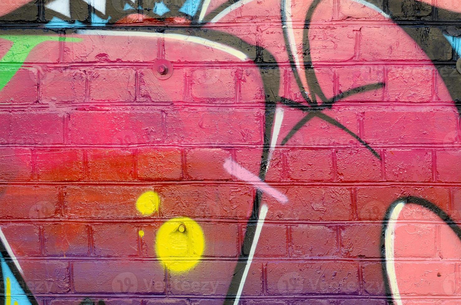 Abstract colorful fragment of graffiti paintings on old brick wall. Street art composition with parts of unwritten letters and multicolored stains. Subcultural background texture photo