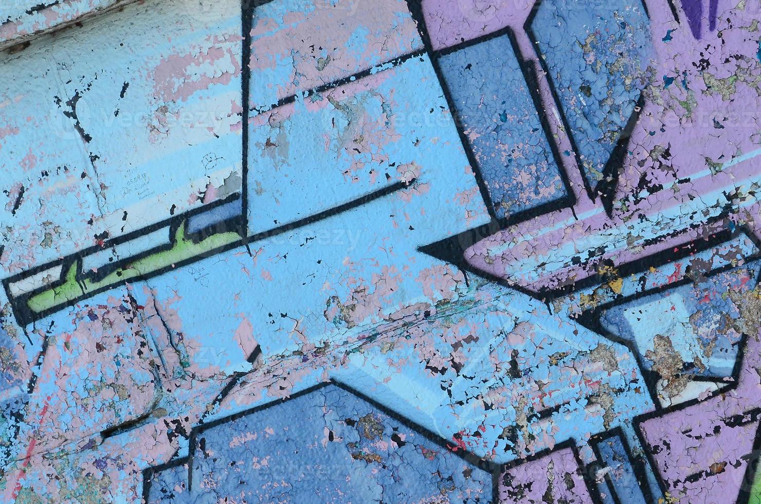 Fragment of graffiti drawings. The old wall decorated with paint stains in the style of street art culture. Colored background texture in cold tones photo