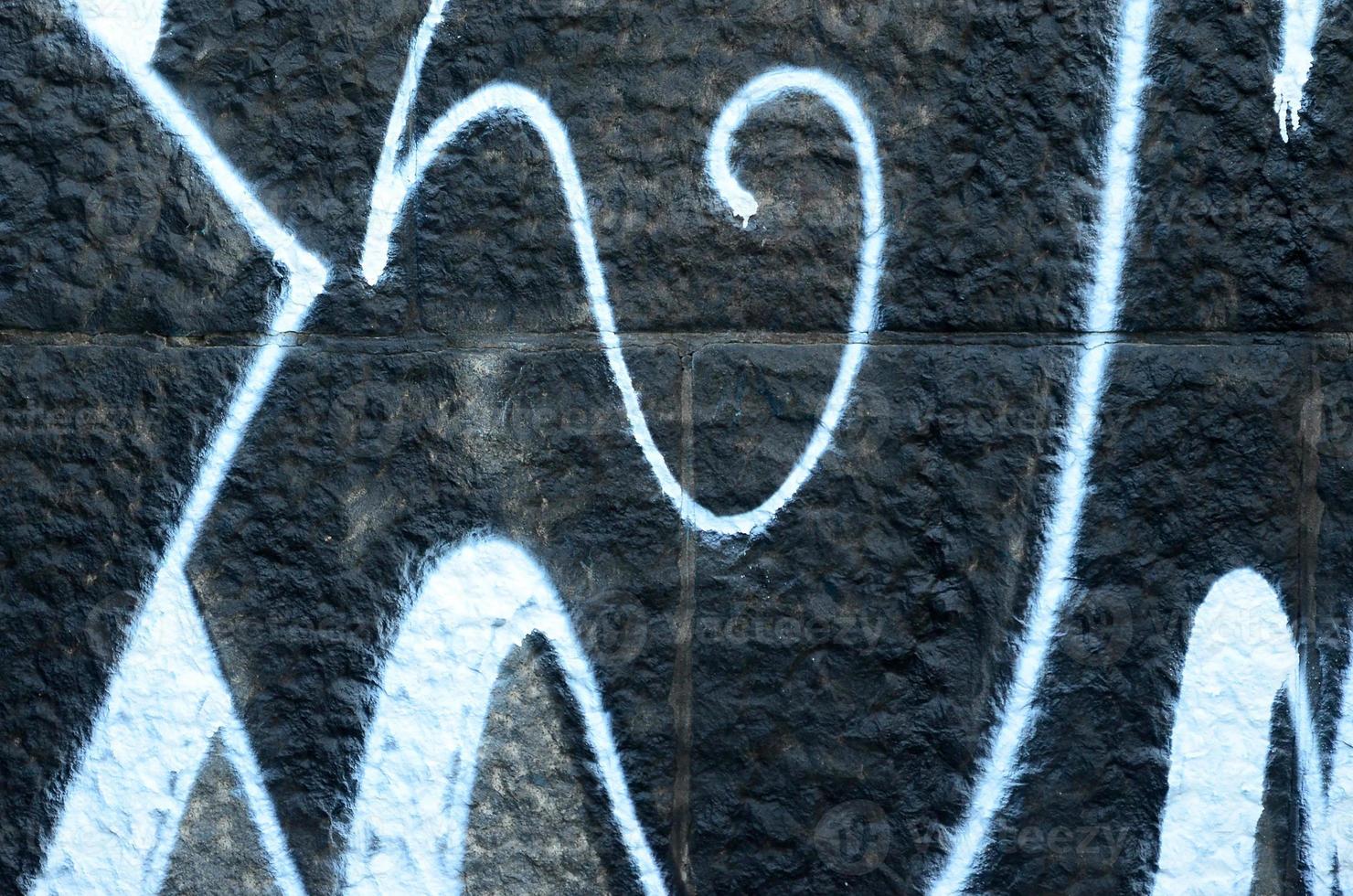 fragmento de dibujos de graffiti. la antigua muralla decorada con manchas de pintura al estilo de la cultura del arte callejero. textura de fondo de color foto