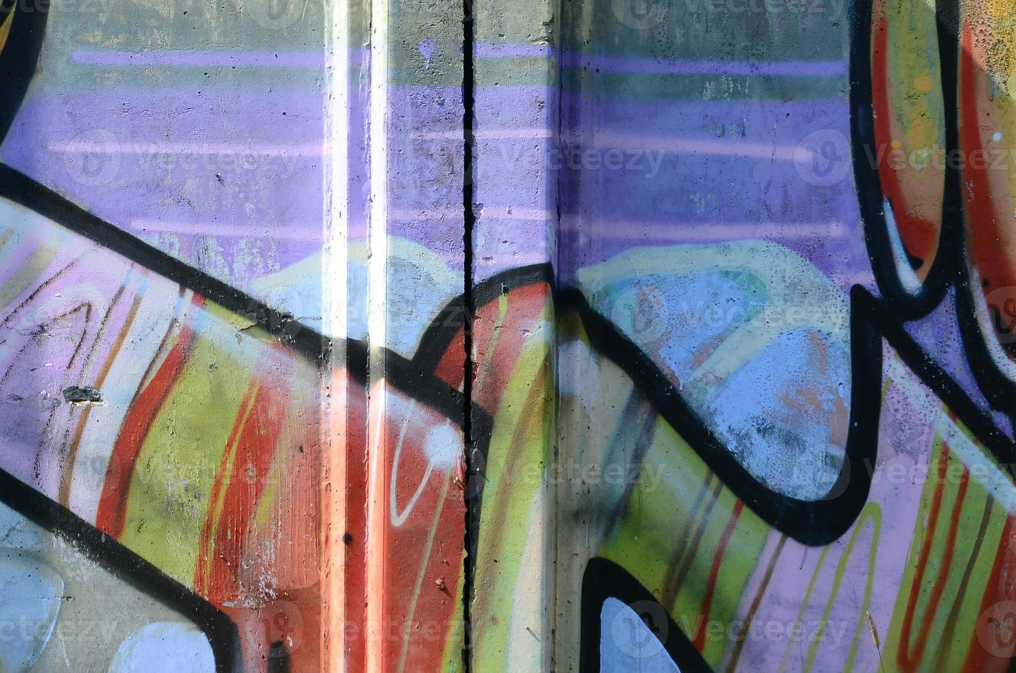 Fragment of graffiti drawings. The old wall decorated with paint stains in the style of street art culture. Multicolored background texture photo