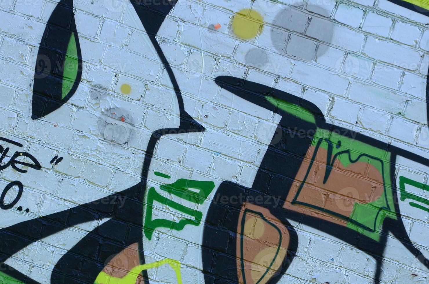 Fragment of graffiti drawings. The old wall decorated with paint stains in the style of street art culture. Colored background texture in green tones photo