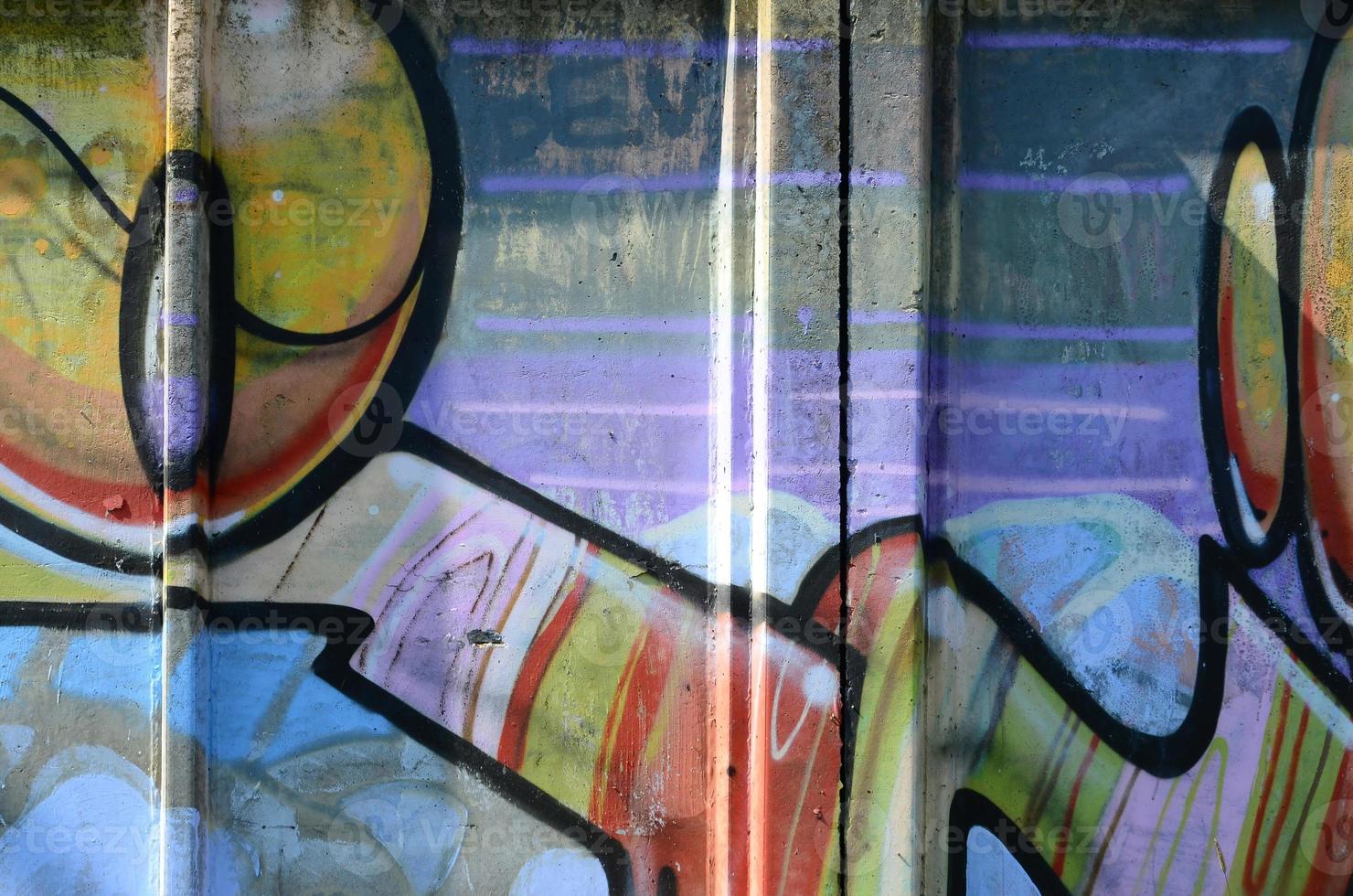 Fragment of graffiti drawings. The old wall decorated with paint stains in the style of street art culture. Multicolored background texture photo