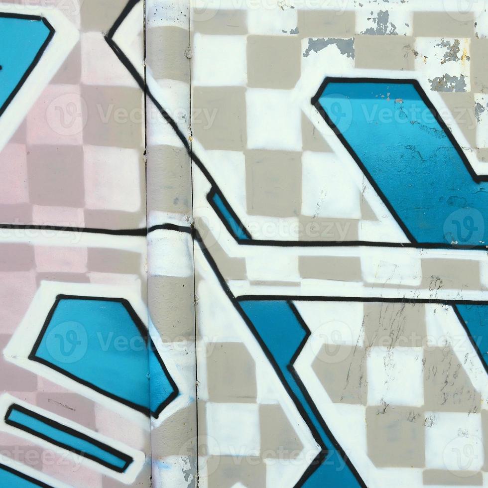 Fragment of graffiti drawings. The old wall decorated with paint stains in the style of street art culture. Colored background texture in cold tones photo