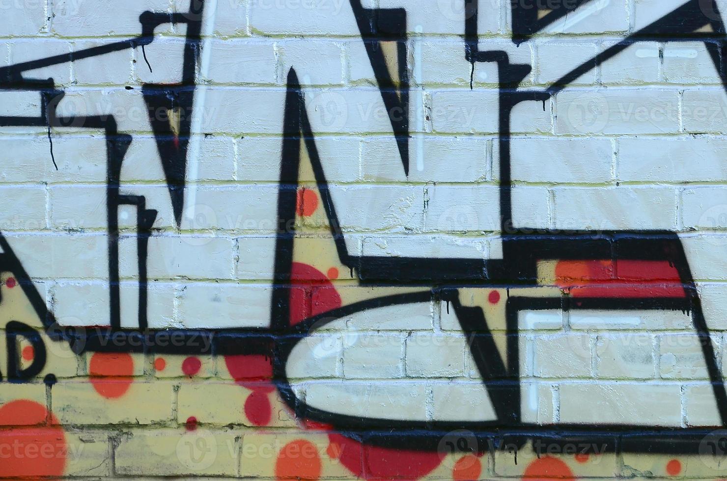 Fragment of graffiti drawings. The old wall decorated with paint stains in the style of street art culture. Colored background texture photo
