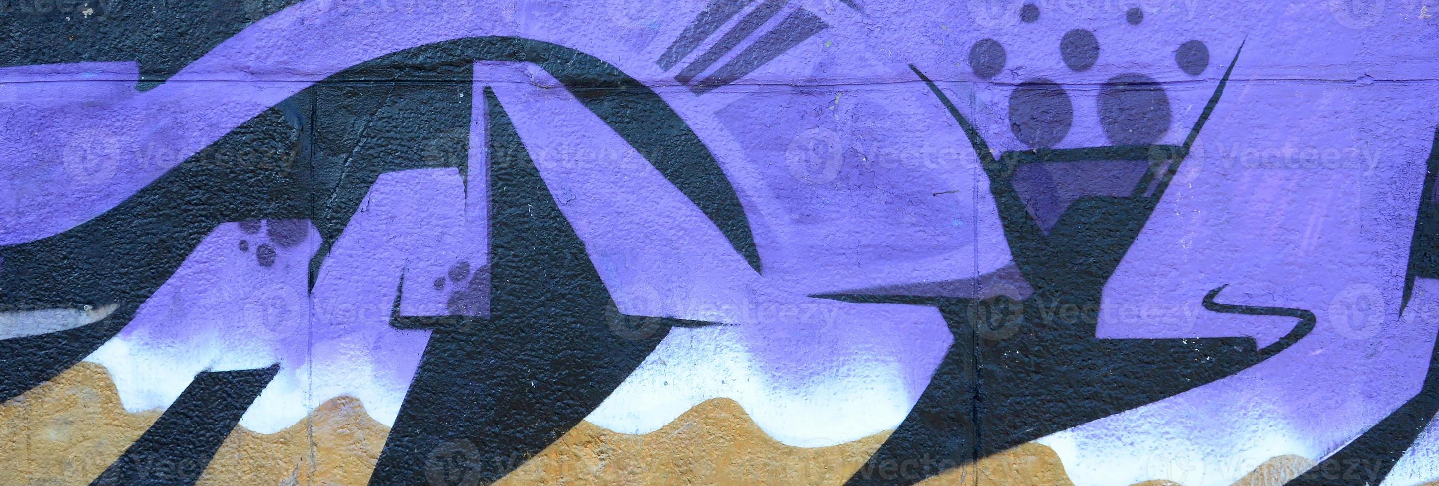 Fragment of graffiti drawings. The old wall decorated with paint stains in the style of street art culture. Colored background texture in purple tones photo