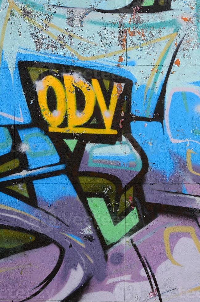 Fragment of graffiti drawings. The old wall decorated with paint stains in the style of street art culture. Colored background texture in cold tones photo