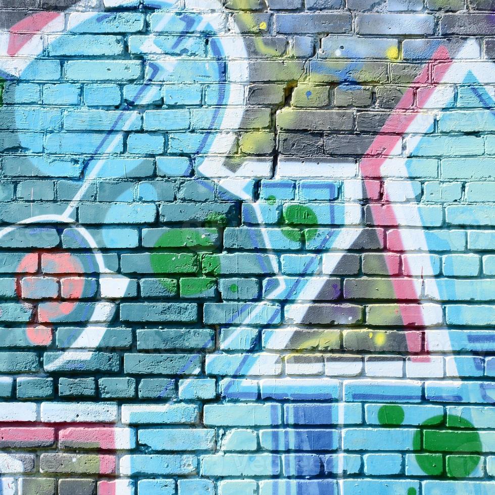 Fragment of graffiti drawings. The old wall decorated with paint stains in the style of street art culture. Colored background texture in cold tones photo