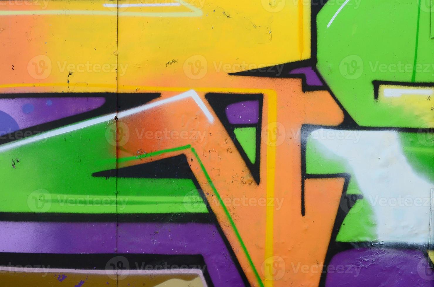 Fragment of graffiti drawings. The old wall decorated with paint stains in the style of street art culture. Multicolored background texture photo