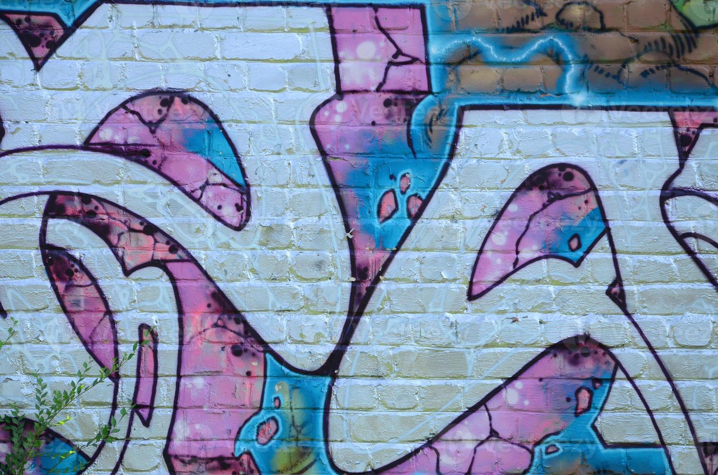 Fragment of graffiti drawings. The old wall decorated with paint stains in the style of street art culture. Colored background texture in purple tones photo