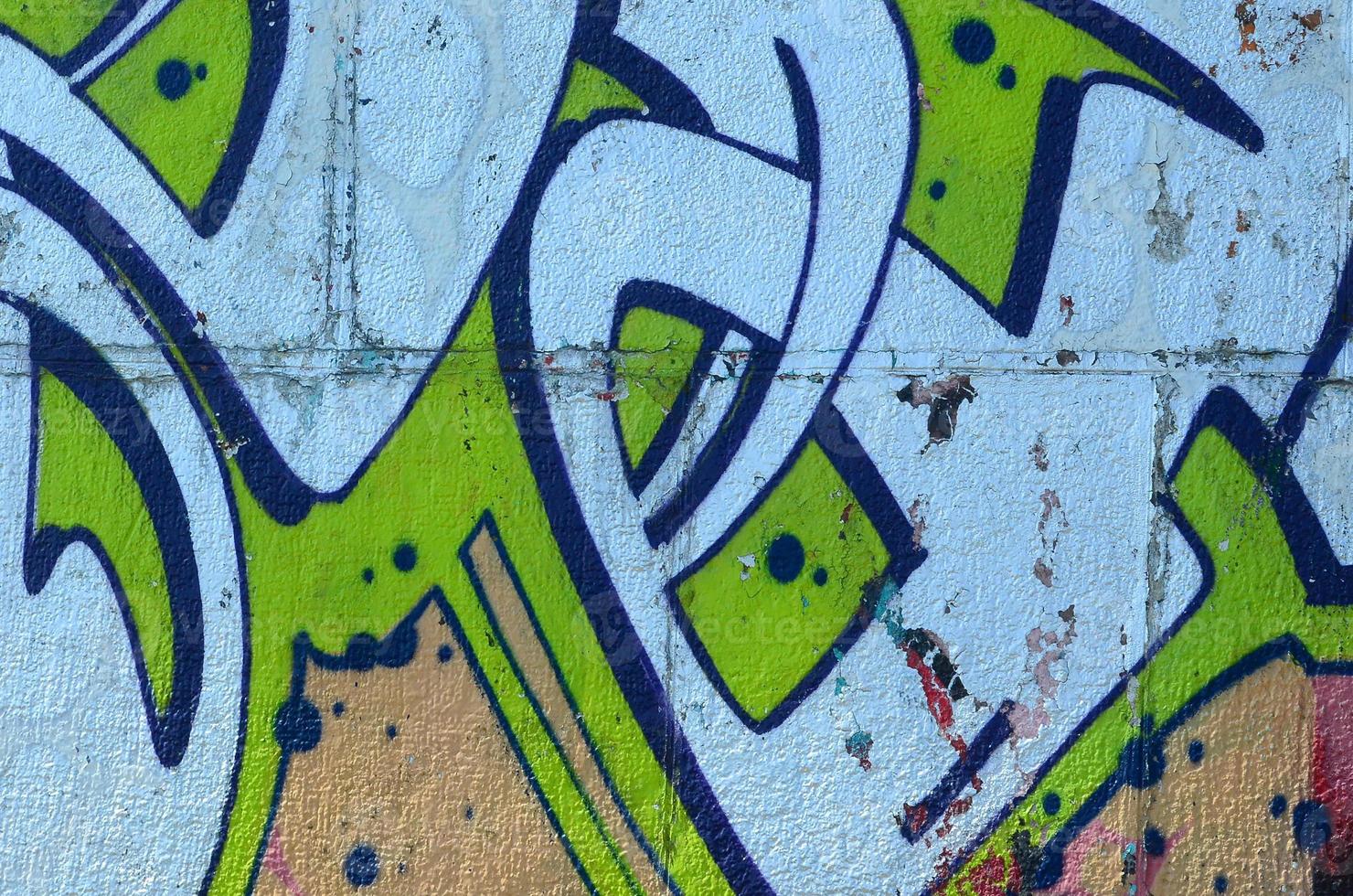 Fragment of graffiti drawings. The old wall decorated with paint stains in the style of street art culture. Colored background texture in green tones photo