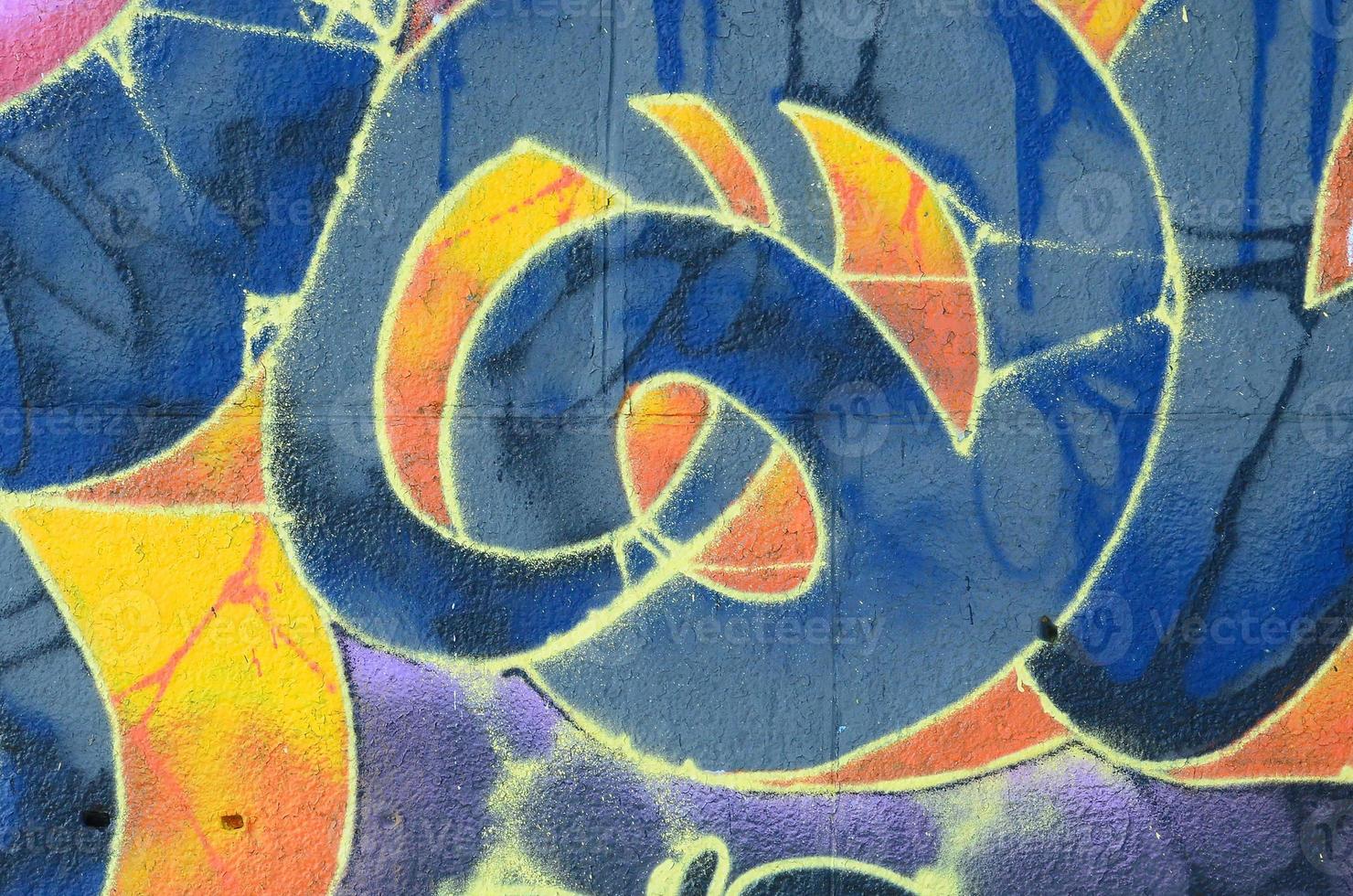 Fragment of graffiti drawings. The old wall decorated with paint stains in the style of street art culture. Multicolored background texture photo