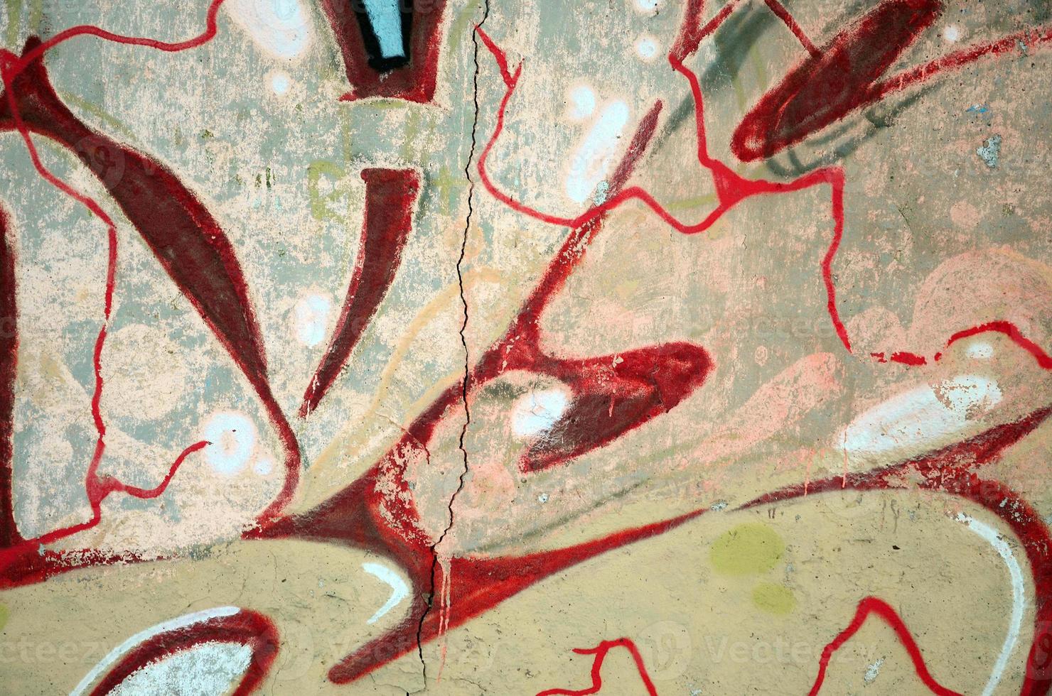 The old wall, painted in color graffiti drawing red aerosol paints. Background image on the theme of drawing graffiti and street art photo