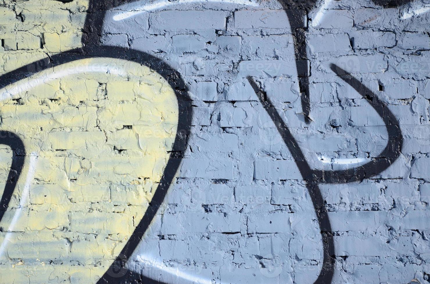 The old wall, painted in color graffiti drawing blue aerosol paints. Background image on the theme of drawing graffiti and street art photo