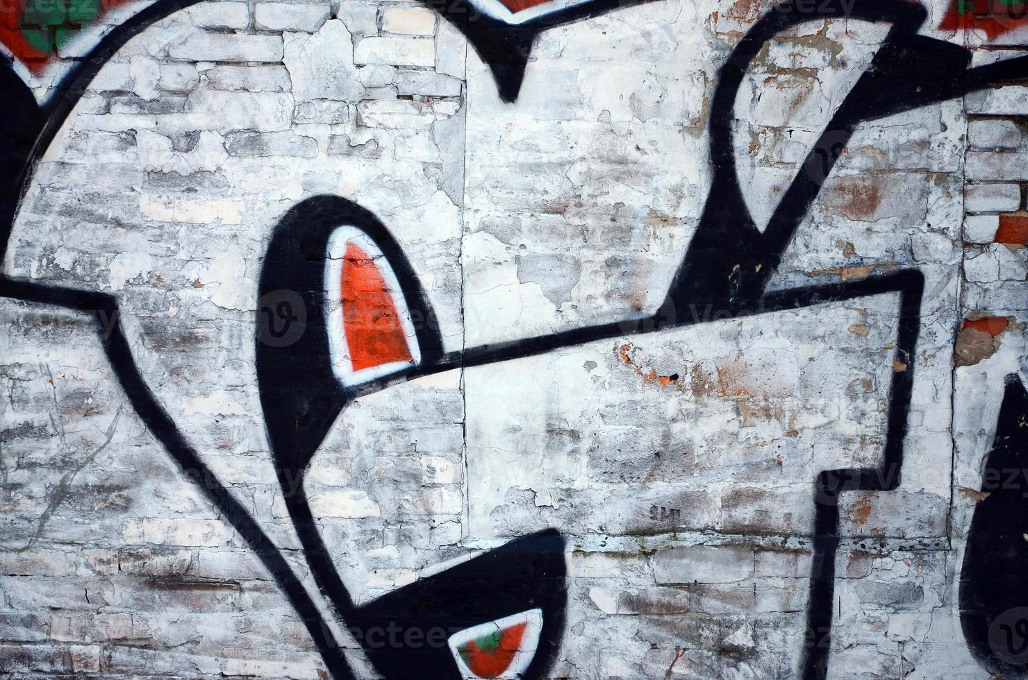 The old wall, painted in color graffiti drawing red aerosol paints. Background image on the theme of drawing graffiti and street art photo