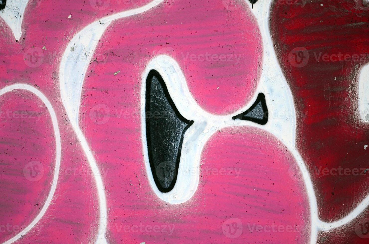 The old wall, painted in color graffiti drawing red aerosol paints. Background image on the theme of drawing graffiti and street art photo