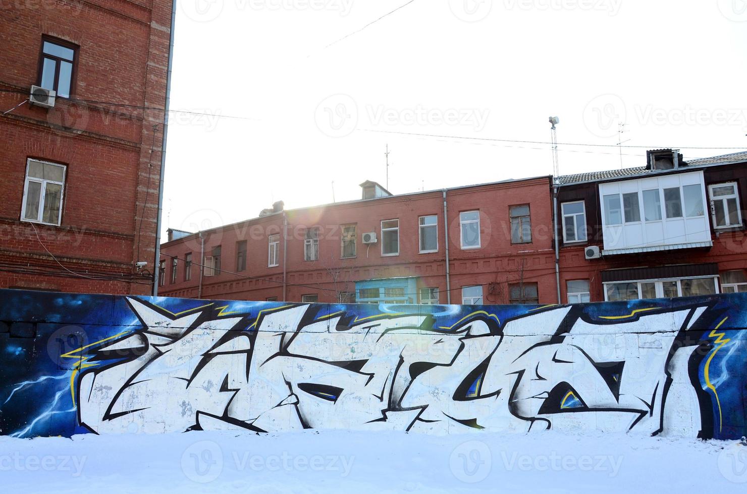 The old wall, painted in color graffiti drawing red aerosol paints. Background image on the theme of drawing graffiti and street art photo