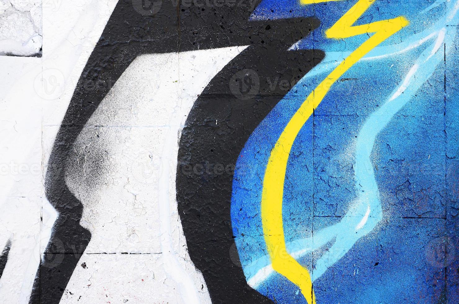 The old wall, painted in color graffiti drawing red aerosol paints. Background image on the theme of drawing graffiti and street art photo