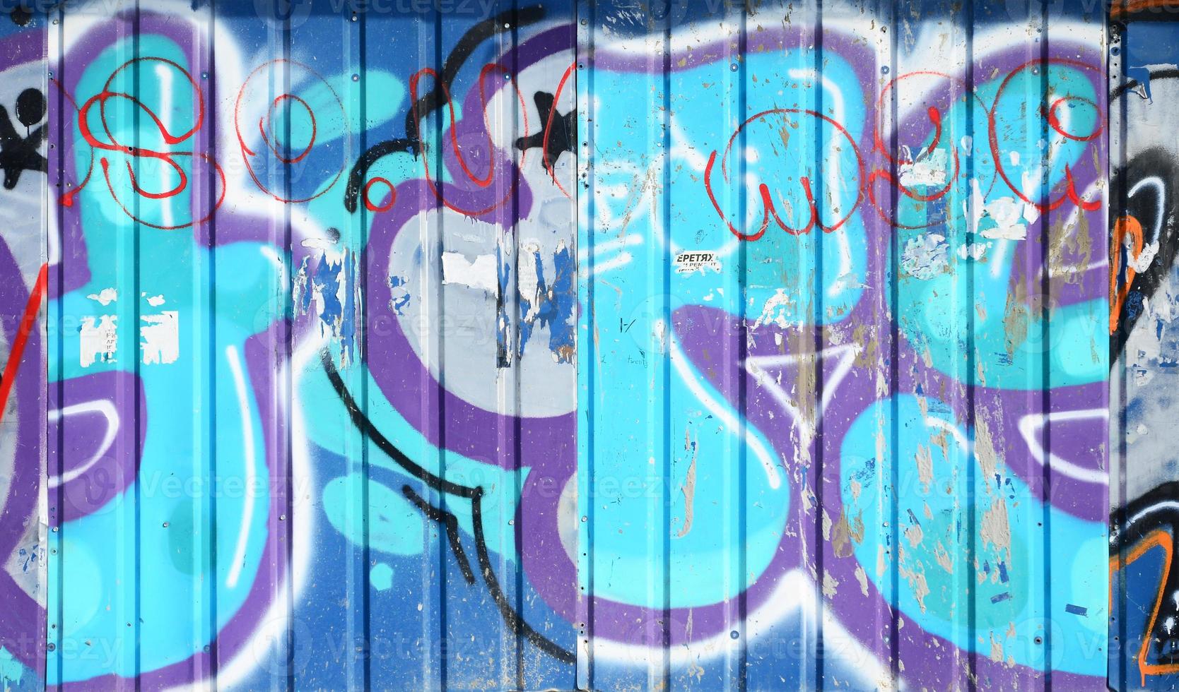 The old wall, painted in color graffiti drawing blue aerosol paints. Background image on the theme of drawing graffiti and street art photo