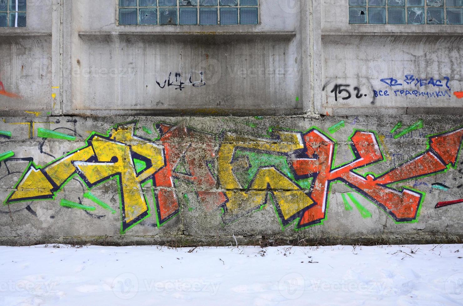 The old wall, painted in color graffiti drawing red aerosol paints. Background image on the theme of drawing graffiti and street art photo