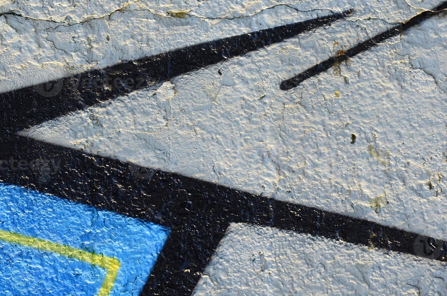 The old wall, painted in color graffiti drawing blue aerosol paints. Background image on the theme of drawing graffiti and street art photo