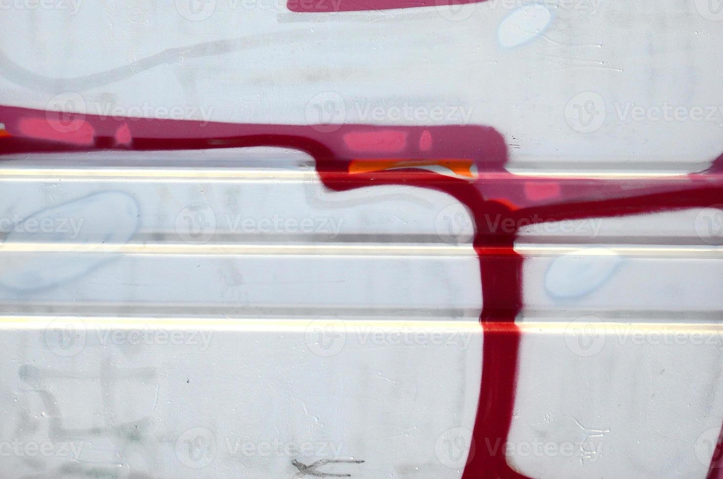 The old wall, painted in color graffiti drawing red aerosol paints. Background image on the theme of drawing graffiti and street art photo