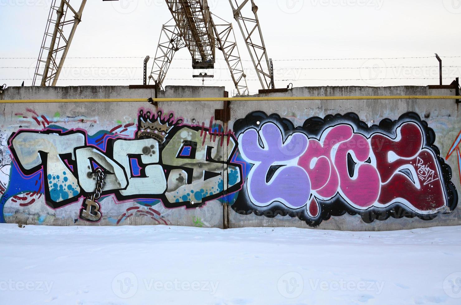 The old wall, painted in color graffiti drawing red aerosol paints. Background image on the theme of drawing graffiti and street art photo