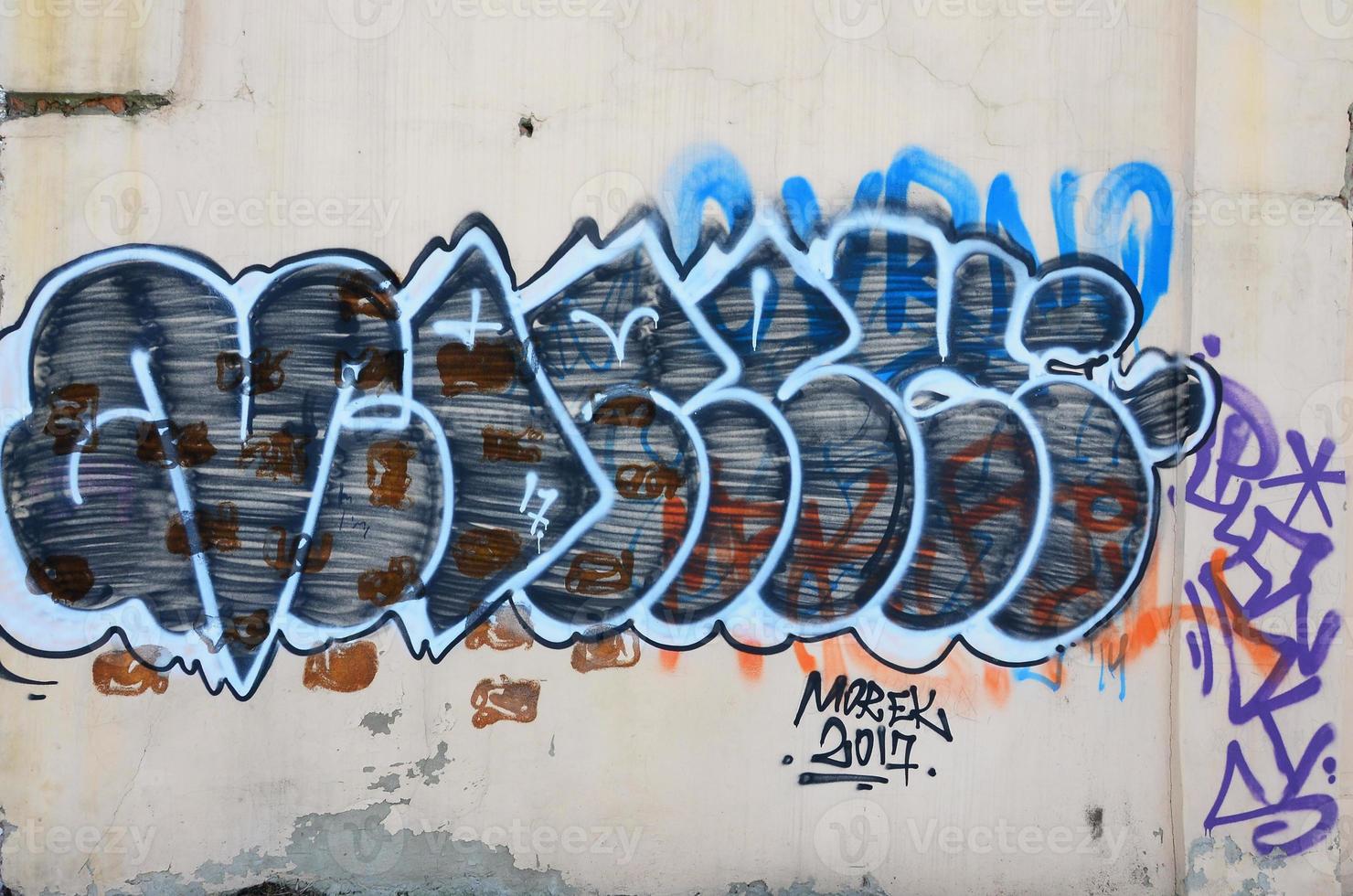 The old wall, painted in color graffiti drawing with aerosol paints. Background image on the theme of drawing graffiti and street art photo