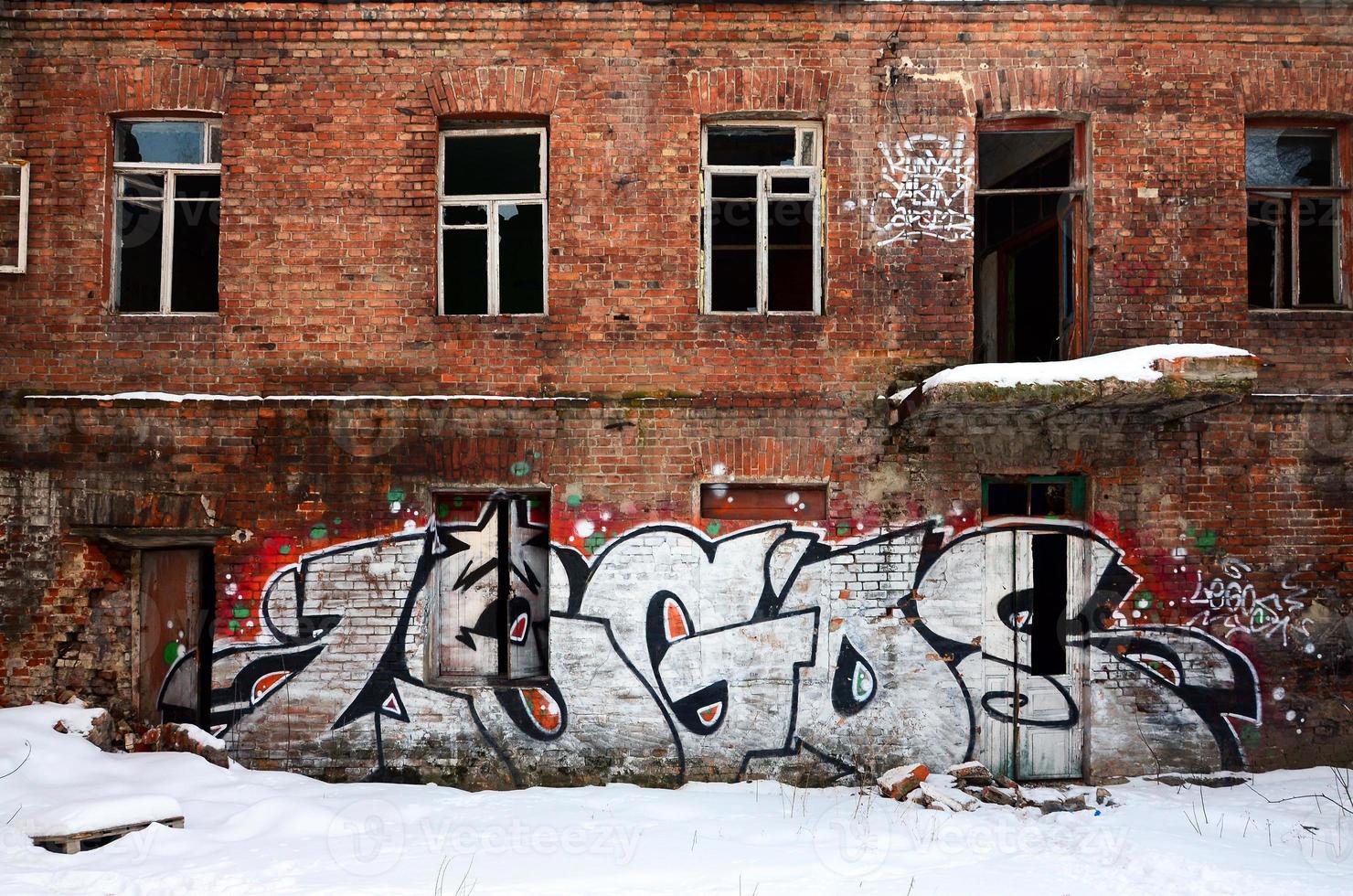 The old wall, painted in color graffiti drawing red aerosol paints. Background image on the theme of drawing graffiti and street art photo