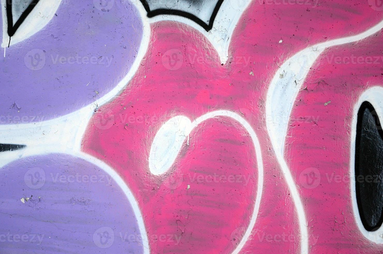 The old wall, painted in color graffiti drawing red aerosol paints. Background image on the theme of drawing graffiti and street art photo