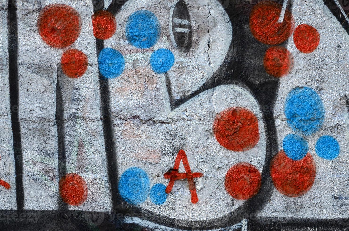 The old wall, painted in color graffiti drawing red aerosol paints. Background image on the theme of drawing graffiti and street art photo