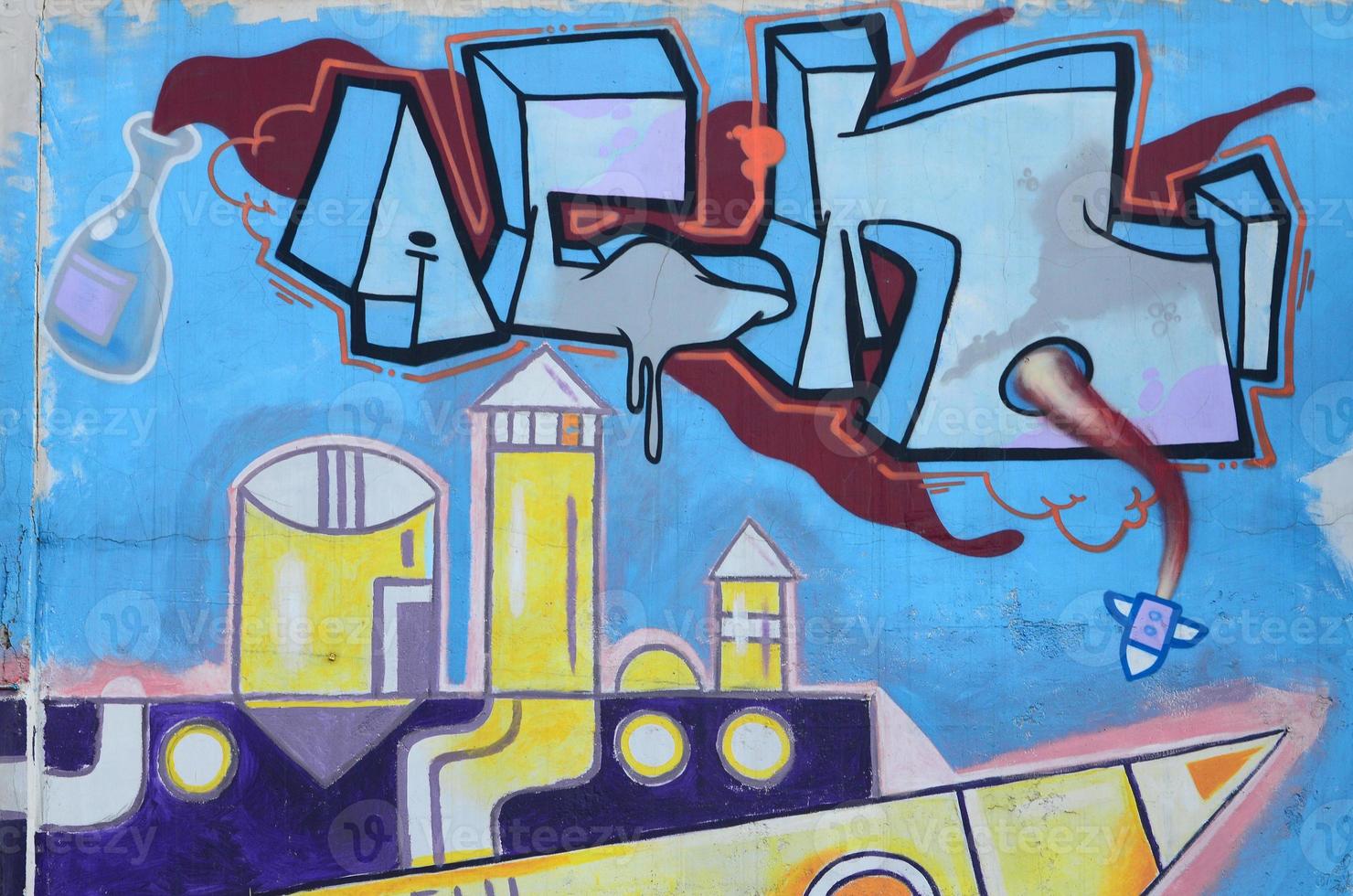 The old wall, painted in color graffiti drawing blue aerosol paints. Background image on the theme of drawing graffiti and street art photo