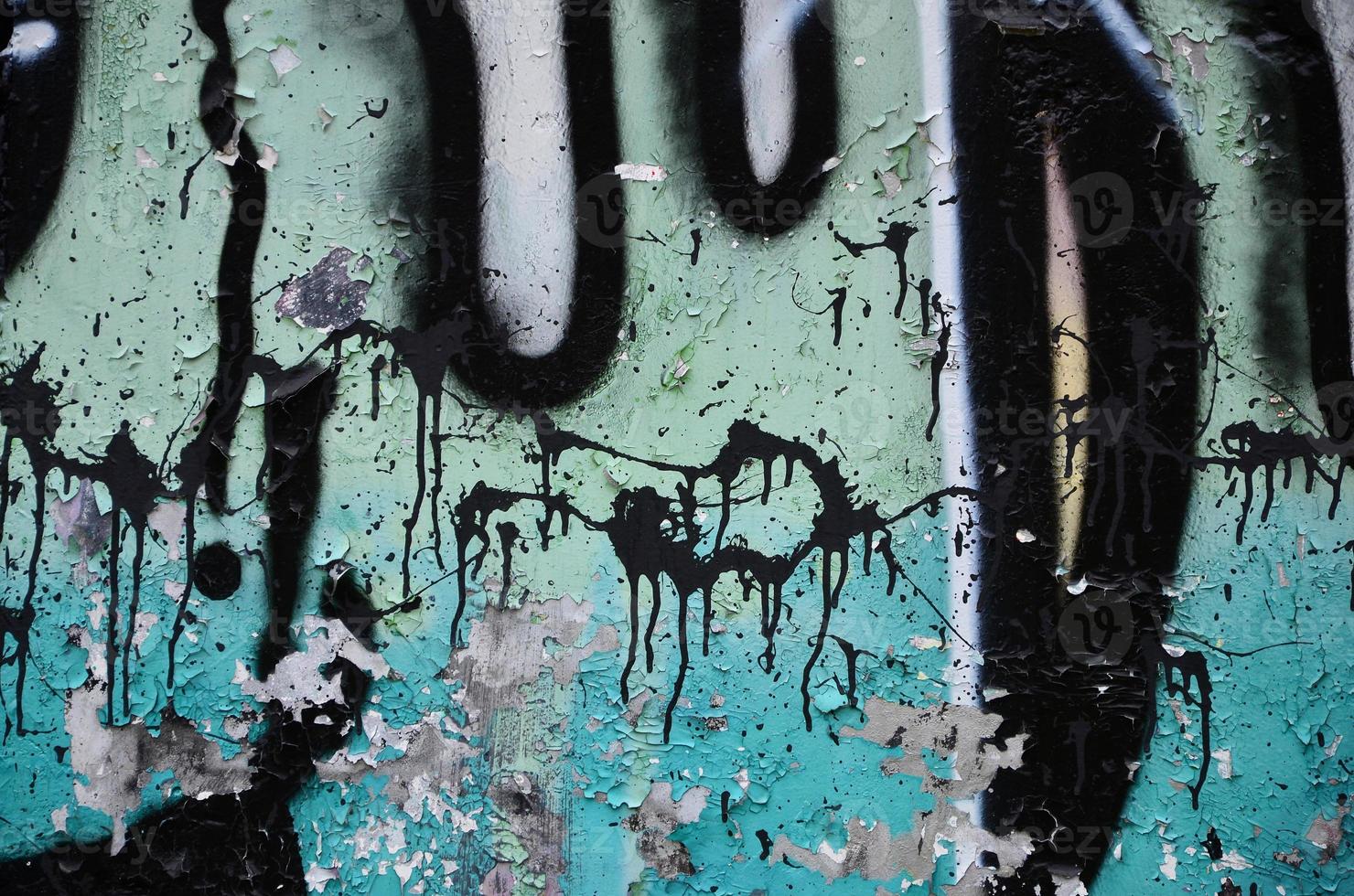 Texture of a fragment of the wall with graffiti painting, which is depicted on it. An image of a piece of graffiti drawing as a photo on street art and graffiti culture topics