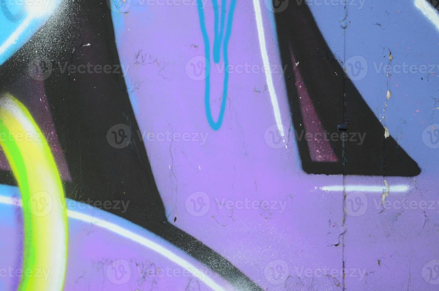 Fragment of graffiti drawings. The old wall decorated with paint stains in the style of street art culture. Colored background texture in cold tones photo