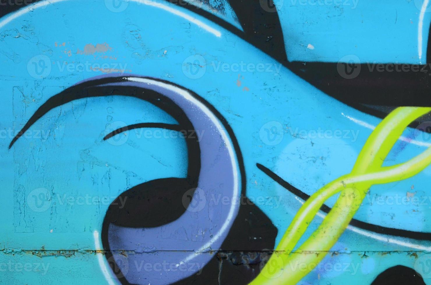 Fragment of graffiti drawings. The old wall decorated with paint stains in the style of street art culture. Colored background texture in cold tones photo