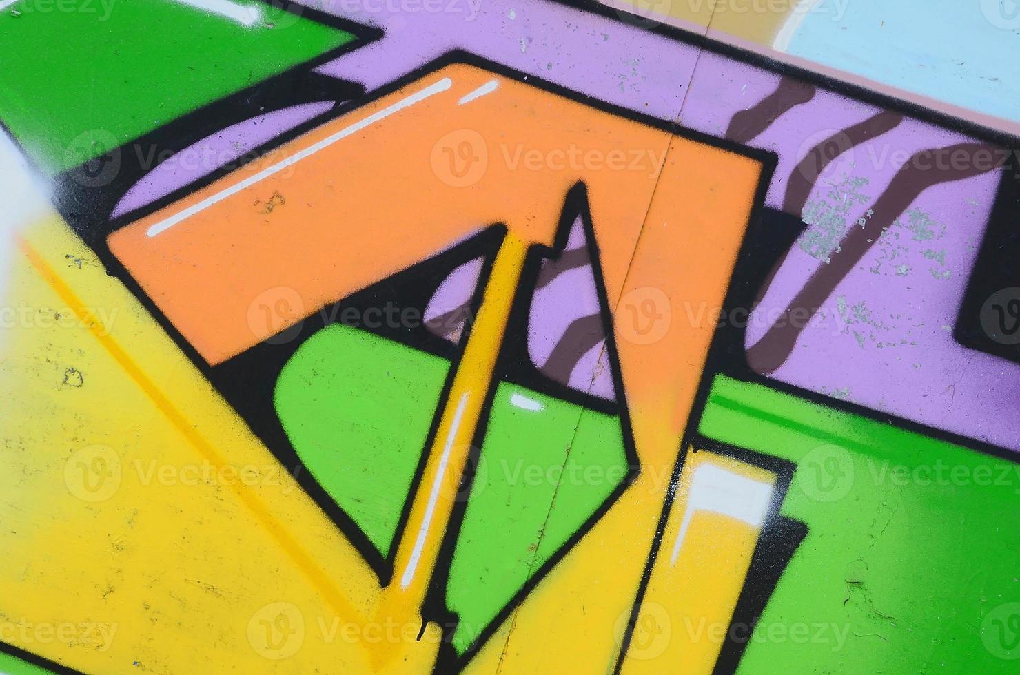 Fragment of graffiti drawings. The old wall decorated with paint stains in the style of street art culture. Multicolored background texture photo