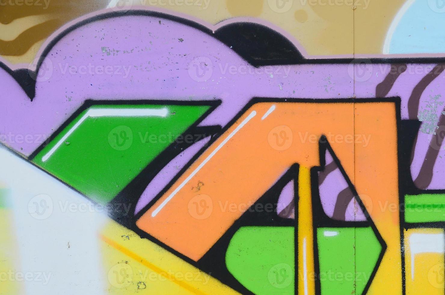 Fragment of graffiti drawings. The old wall decorated with paint stains in the style of street art culture. Multicolored background texture photo