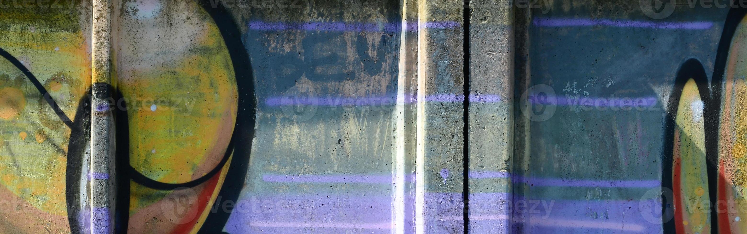 Fragment of graffiti drawings. The old wall decorated with paint stains in the style of street art culture. Multicolored background texture photo