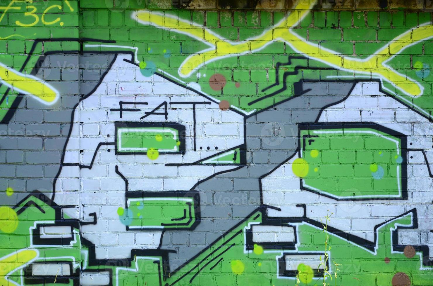 Fragment of graffiti drawings. The old wall decorated with paint stains in the style of street art culture. Colored background texture in green tones photo
