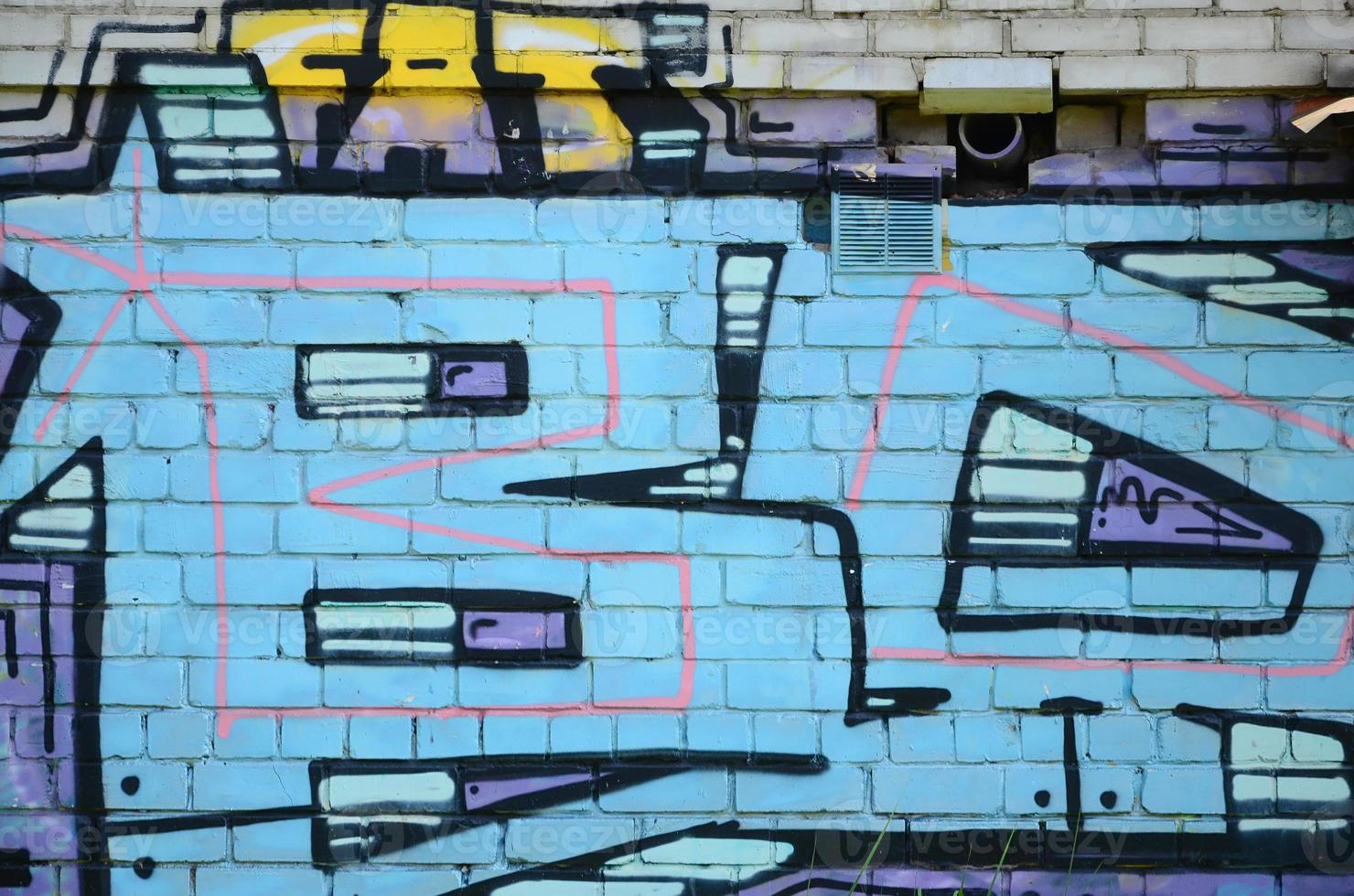 Fragment of graffiti drawings. The old wall decorated with paint stains in the style of street art culture. Colored background texture in cold tones photo
