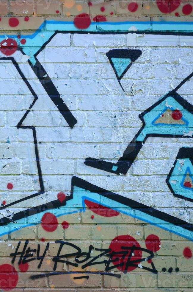 Fragment of graffiti drawings. The old wall decorated with paint stains in the style of street art culture. Colored background texture in cold tones photo