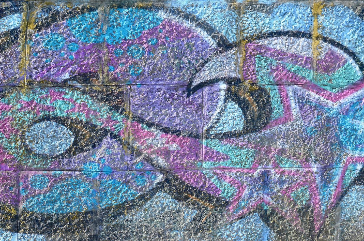 Fragment of graffiti drawings. The old wall decorated with paint stains in the style of street art culture. Colored background texture in purple tones photo
