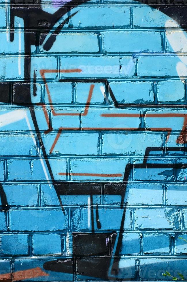 Fragment of graffiti drawings. The old wall decorated with paint stains in the style of street art culture. Colored background texture in cold tones photo