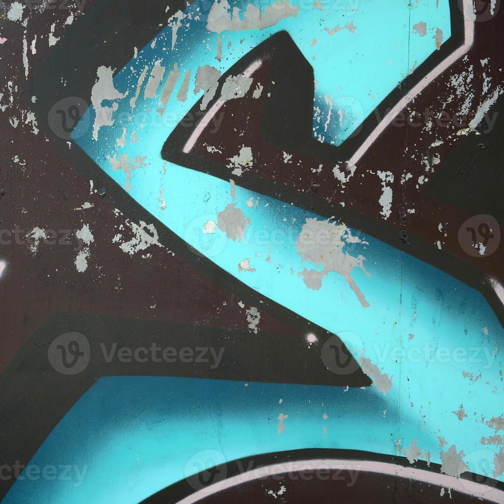 Fragment of graffiti drawings. The old wall decorated with paint stains in the style of street art culture. Colored background texture in cold tones photo