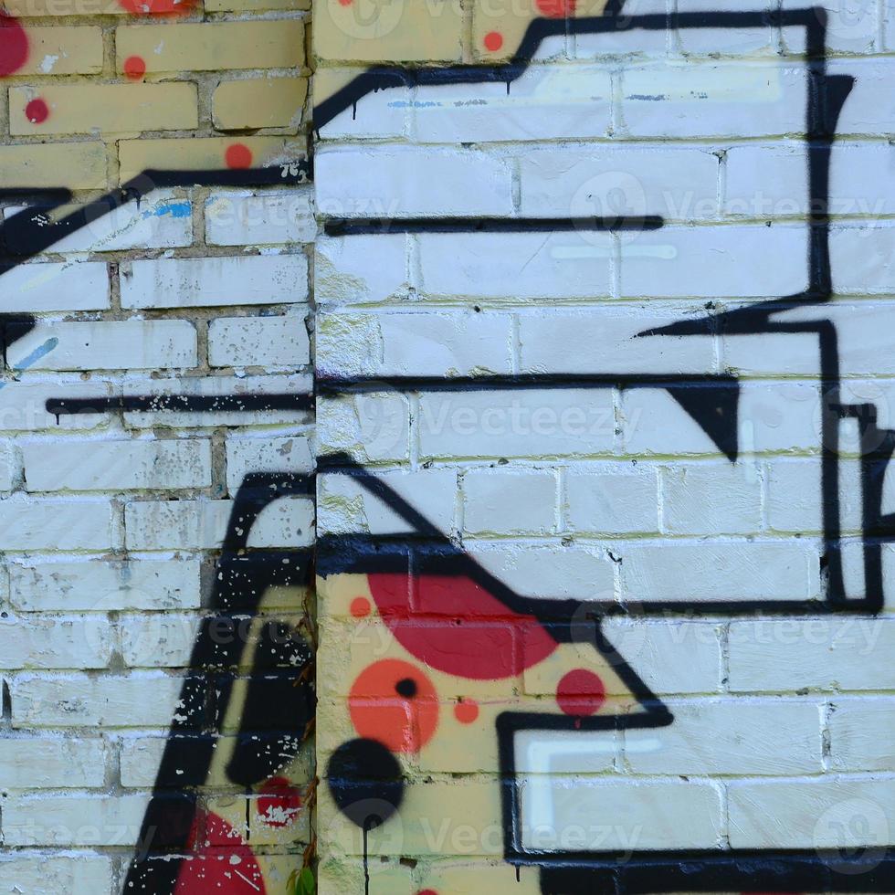 Fragment of graffiti drawings. The old wall decorated with paint stains in the style of street art culture. Colored background texture photo